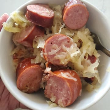 Kielbasa and Sauerkraut in a white bowl