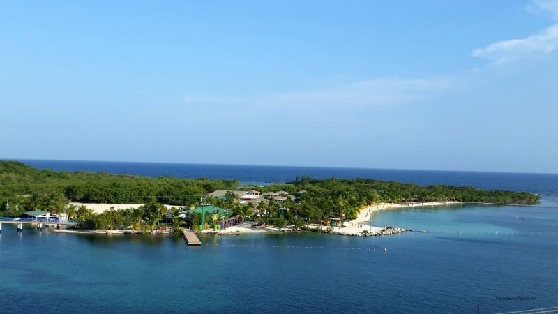 looking out over a tropical island with buildings and sandy beach