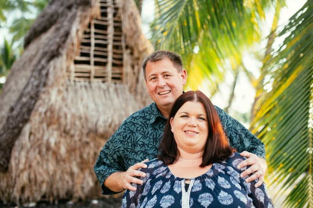 Tammilee and John next to palm trees