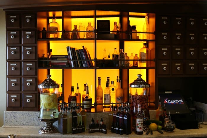 Alchemy Bar on a Carnival Cruise Ship with bottles and books on shelves
