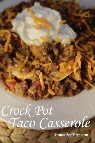 Crock Pot Taco Casserole under a white bowl filled with ground beef casserole topped with sour cream and cheddar cheese