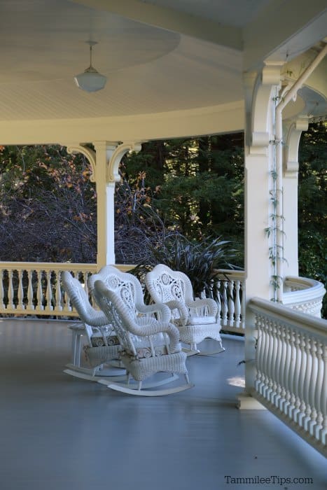 Large porch with ornate rocking chairs on it