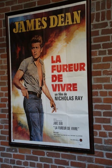 James Dean movie poster for La Fureur De Vivre mounted on a brick wall
