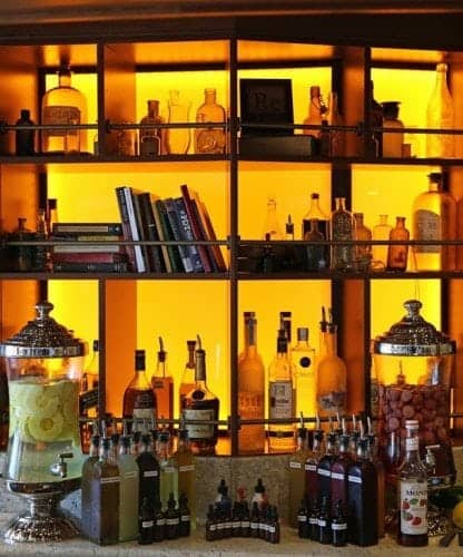 Alchemy Bar background with bottles and mixers