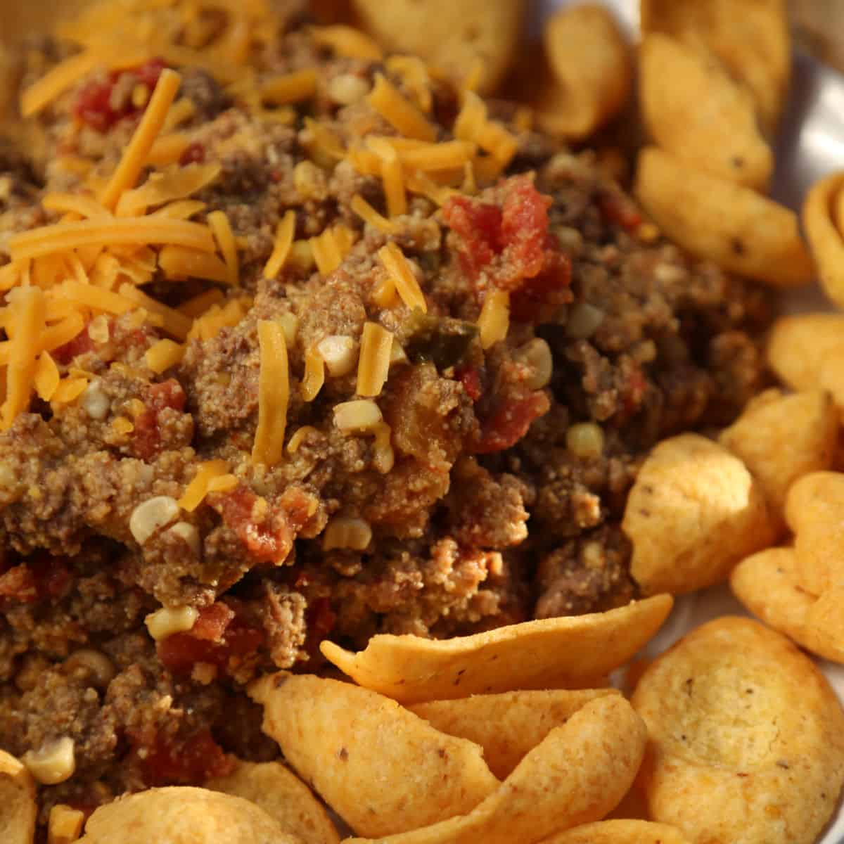 spicy taco beef with cheese next to Frito Chips