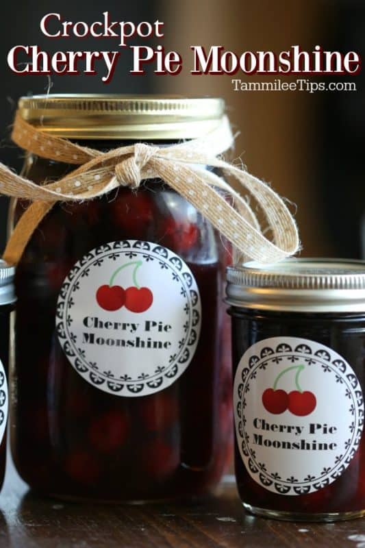 Crockpot Cherry Pie Moonshine over two mason jars with labels and ribbon