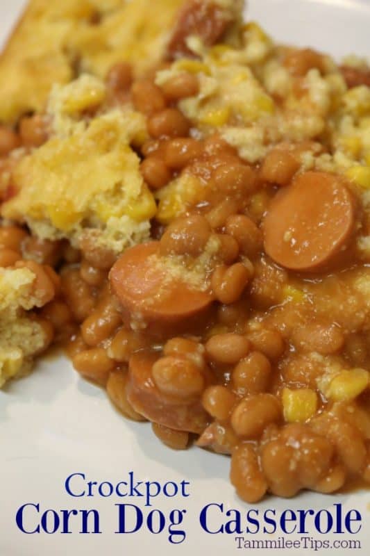 Crockpot Corn Dog Casserole under a white plate filled with hot dogs, beans and cornbread topping