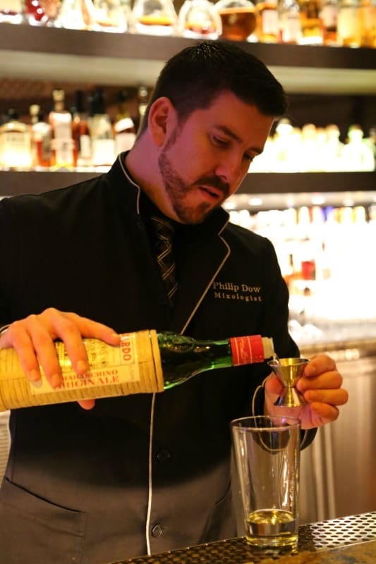 bartender pouring Luxardo liqueur in a jigger