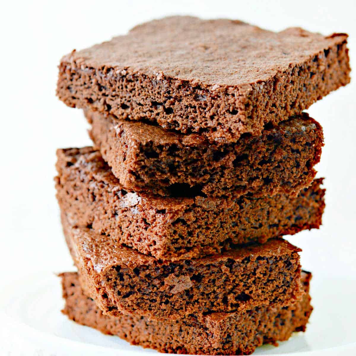 Classic Chocolate Brownies stacked on a white plate