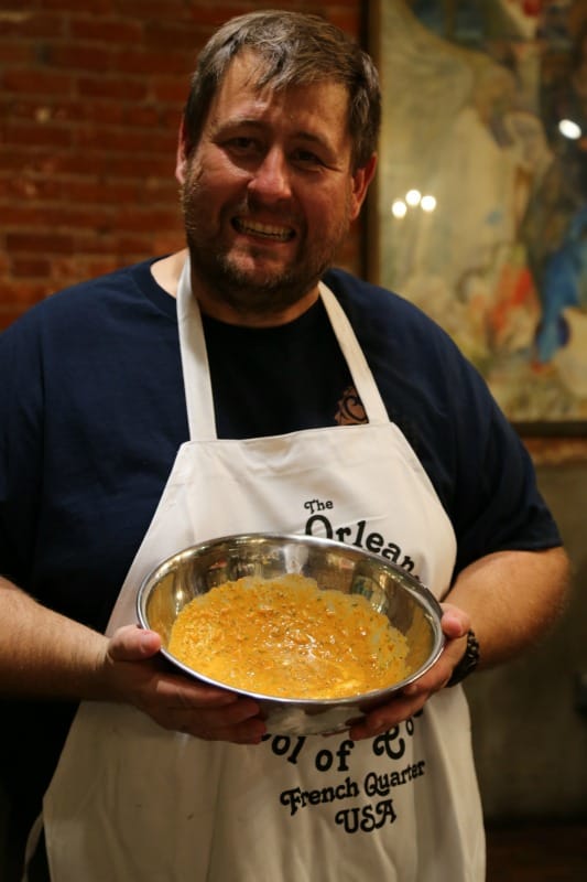 John holding a silver bowl of remoulade