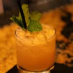mai tai cocktail with a mint leaf garnish in a rocks glass