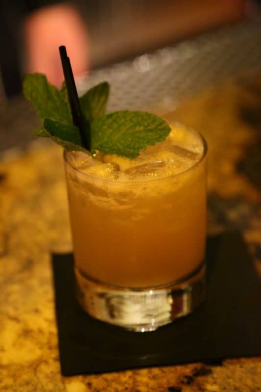 Mai Tai with mint leave garnish in a rocks glass on a black napkin