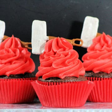 Red cupcakes topped with replica Thor hammer