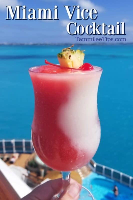 Miami Vice Cocktail in a hurricane glass with a pineapple wedge and cherry near bright blue ocean water
