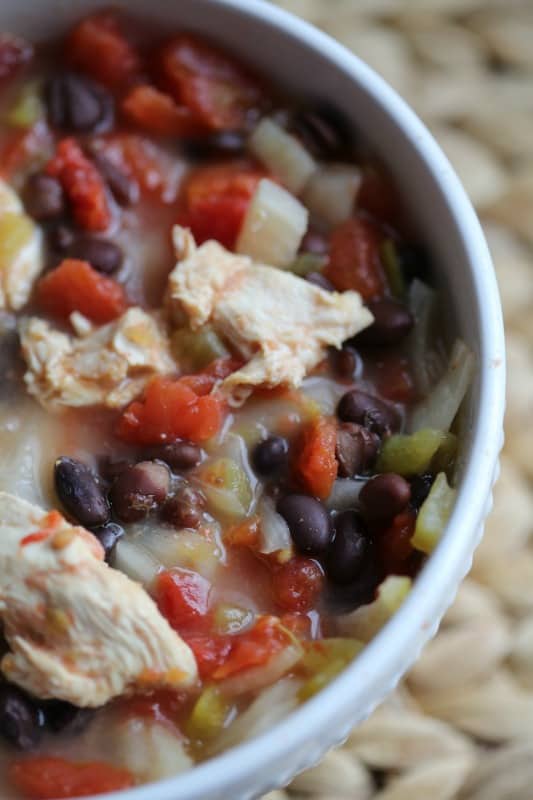 chicken chili in a white bowl on a placemat