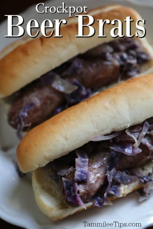 Crockpot Beer Brats over a white plate with two brats on buns