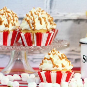 Fluffernutter Cupcake on a cake stand surrounded by mini marshmallows