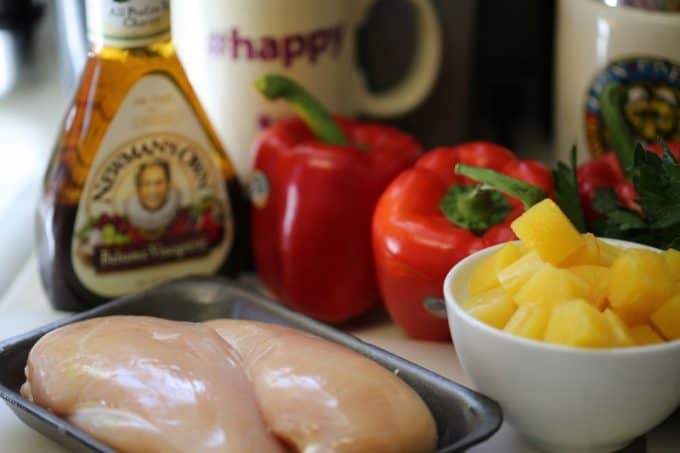 balsamic dressing, chicken breast, red peppers, and pineapple on a counter