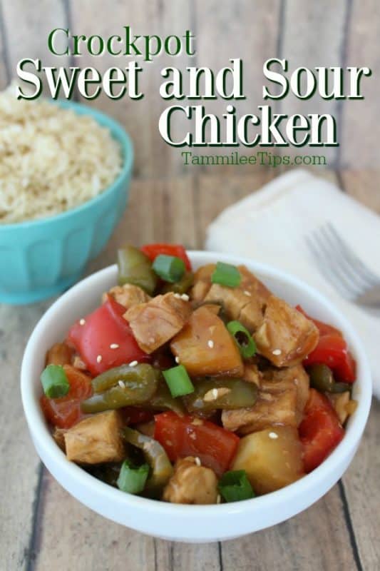 Crockpot Sweet & Sour Chicken in a white bowl next to a bowl of rice, fork, and cloth napkin