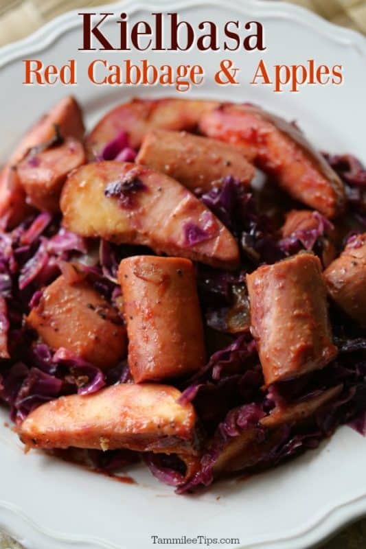 Kielbasa red cabbage and apples over a white plate with cooked kielbasa, apples, and cabbage