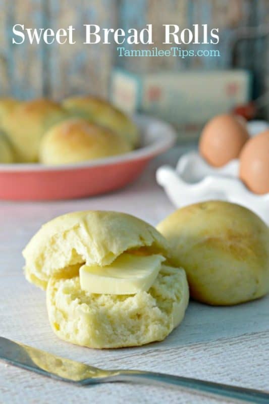 Sweet Bread Rolls over two rolls and a knife on a table near eggs and more rolls