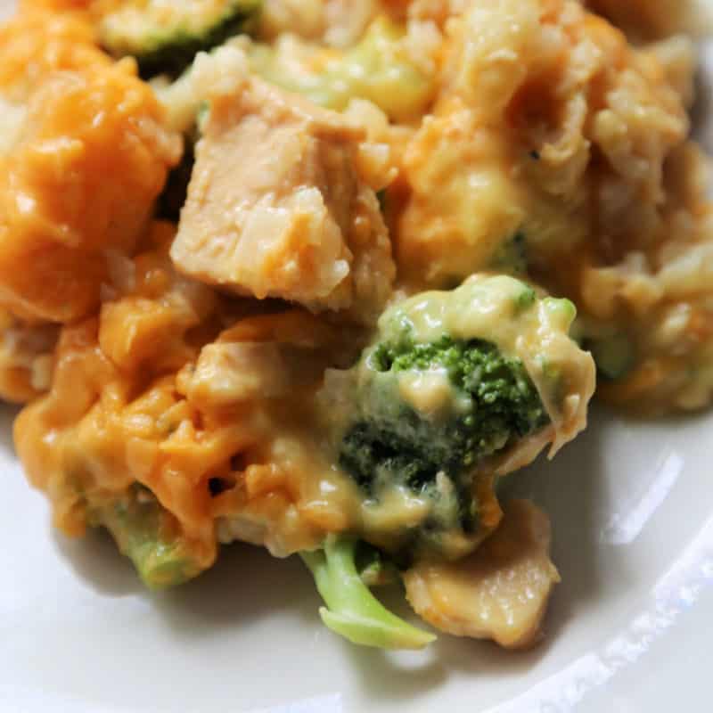tater tot chicken casserole with broccoli on a white plate