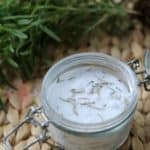 Rosemary bath salts in a glass container