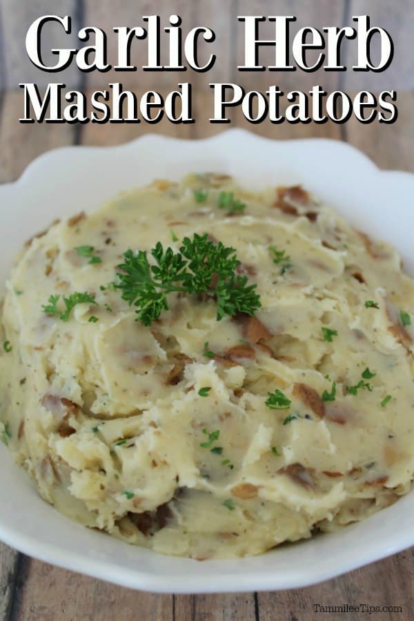 Garlic Herbed Mashed Potatoes over a white bowl filled with herb mashed potatoes