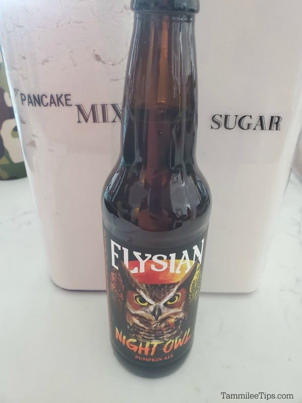 Elysian Night Owl Pumpkin Ale, Pancake mix, and sugar on a white counter. 