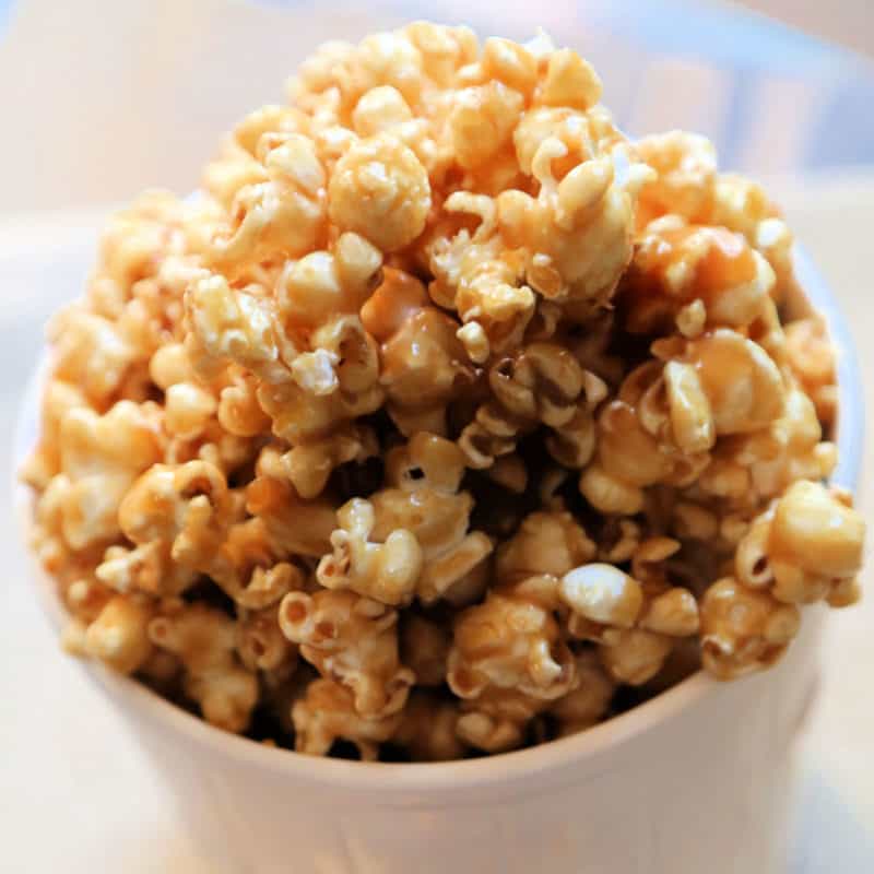 Salted Caramel Popcorn in a white popcorn tub