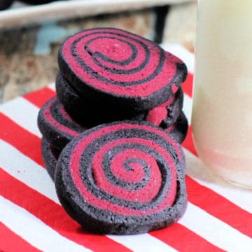 Halloween Pinwheel Cookies on a napkin next to a bottle of milk