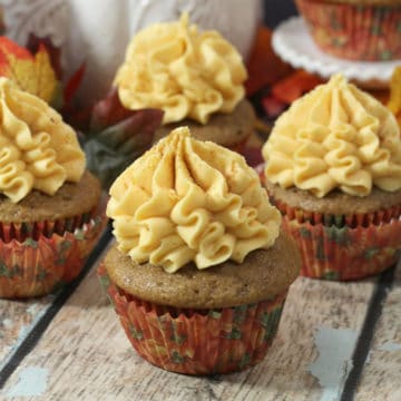 Pumpkin Cupcakes with Maple Icing on a wood board