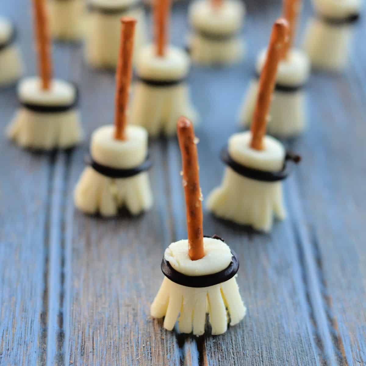 witches broom pretzel sticks lined up on a blue background