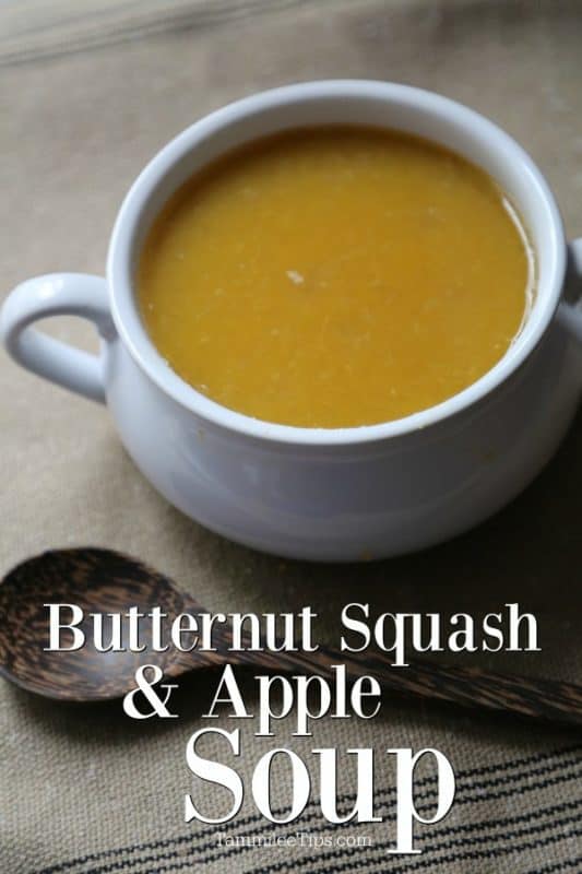 Butternut squash and apple soup text below a white bowl and a wood spoon