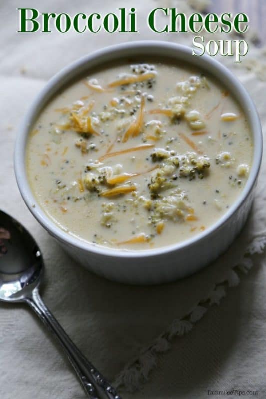Broccoli Cheese Soup over a white bowl with soup and a silver spoon