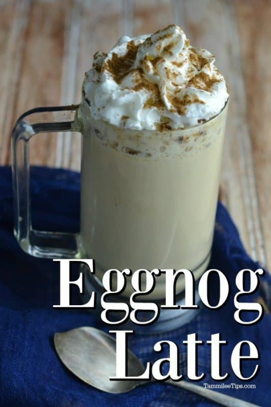 Eggnog Latte under a glass mug filled with a latte topped with whipped cream and cinnamon