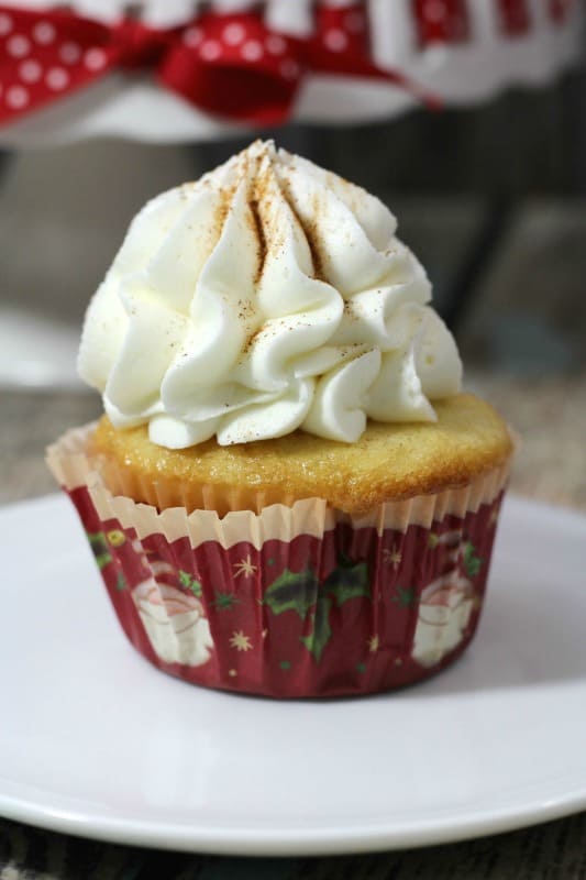 eggnog cupcake in a Santa red cupcake liner with white icing