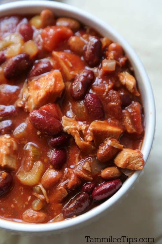 Close up pic of crockpot turkey chili in a white bowl with a white background. 