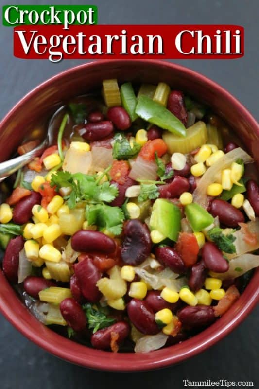 Crockpot Vegetarian Chili in a red bowl on a grey background with a silver spoon in the bowl filled with corn, beans, celery and peppers. 