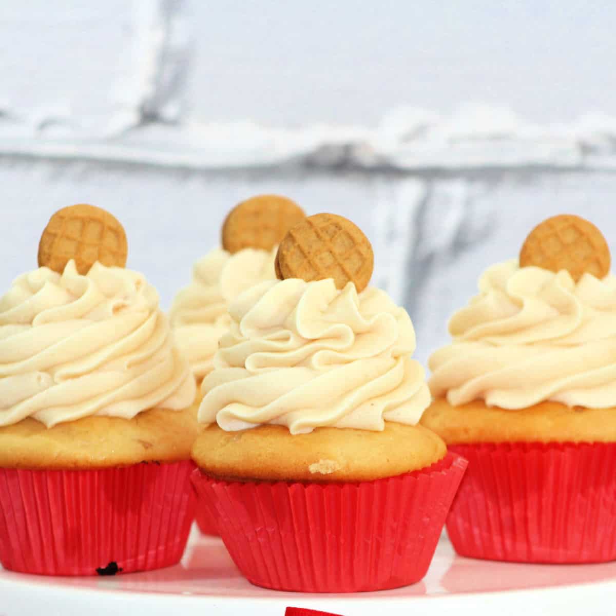 Nutter Butter Cupcakes in red paper wrappers on a white plate