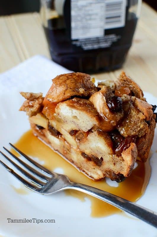 Apple Raisin French Toast on a white plate with syrup and a silver spoon