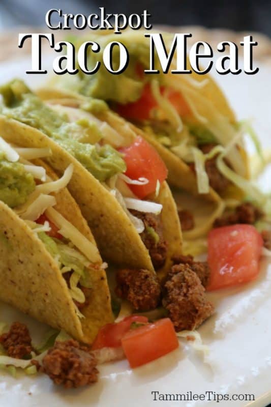 Crockpot Taco Meat over three tacos with ground beef, lettuce, and tomatoes