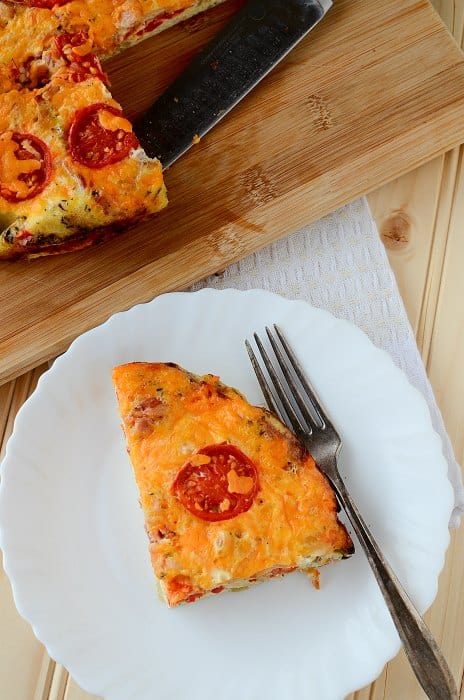 tomato cheese and egg casserole slice on a white plate