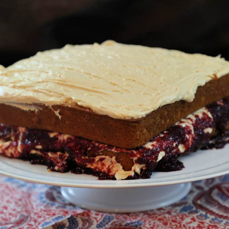 Peanut Butter and Jelly Cake on a white cake platter