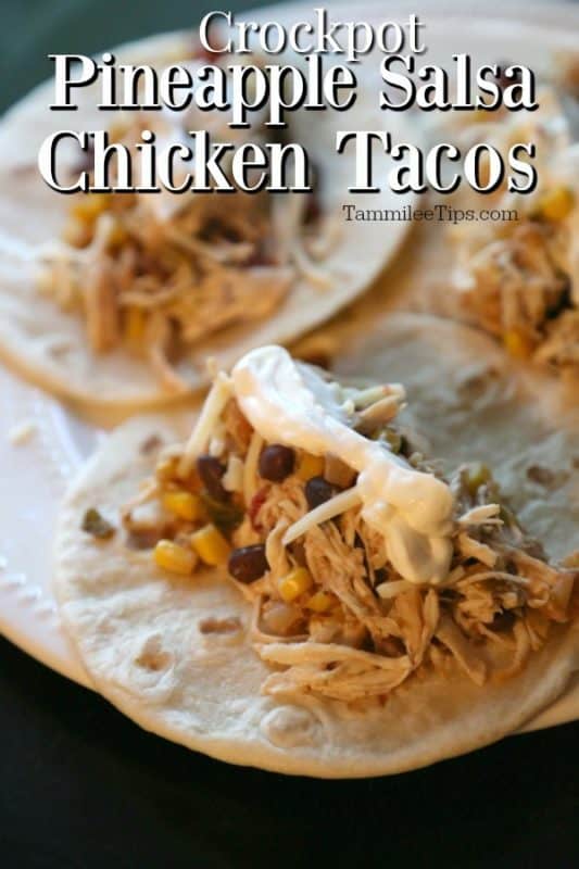 Crockpot Pineapple salsa chicken tacos over a plate with three tacos