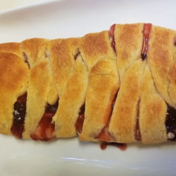 Strawberry Brie Braided Crescent on a white platter