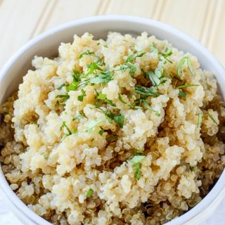 How to make Quinoa in the crockpot text over a large bowl of quinoa