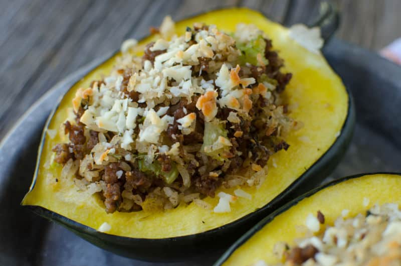 stuffed acorn squash with sausage and rice on a plate