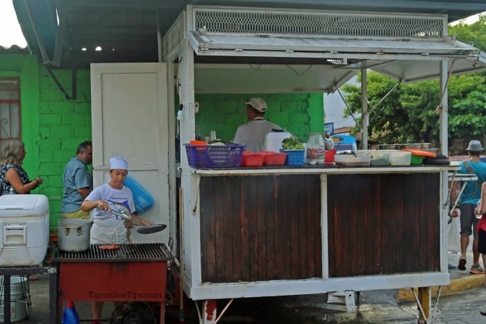 Taco truck in Puerto Vallarta near a green building. 