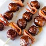 Super easy Crock Pot Bourbon Bacon Meatball recipe is a great new years eve appetizer or super bowl appetizer recipe! The slow cooker does the work and you get a killer recipe to serve at your party!